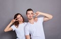 Happy funny joyful young mad couple on a gray background