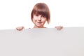 Happy funny little child girl laughing behind a white board. Space for text Royalty Free Stock Photo