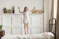 Happy funny child girl jumping on bed alone feeling joy Royalty Free Stock Photo