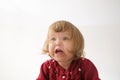 Happy funny little girl emotional playing. cute caucasian blond baby girl with bear and doll