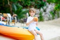 Little kid boy drinking coconut juice on tropical beach Royalty Free Stock Photo