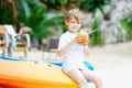 Little kid boy drinking coconut juice on tropical beach Royalty Free Stock Photo