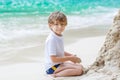 Little kid boy building sand castle on tropical beach Royalty Free Stock Photo