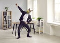 Happy funny office worker in donkey mask dancing and having fun at end of work day