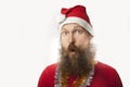 Happy funny santa claus with real beard and red hat and shirt making crazy face and smiling, looking and camera Royalty Free Stock Photo