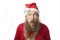 Happy funny santa claus with real beard and red hat and shirt making crazy face and smiling, looking and camera Royalty Free Stock Photo