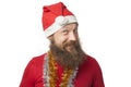 Happy funny santa claus with real beard and red hat and shirt making crazy face and smiling, looking and camera