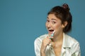 Happy funny teen girl brush her teeth, healthy concept. Morning theme, over blue Royalty Free Stock Photo