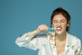 Happy funny teen girl brush her teeth, healthy concept. Morning theme, over blue Royalty Free Stock Photo