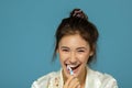 Happy funny teen girl brush her teeth, healthy concept. Morning theme, over blue Royalty Free Stock Photo