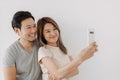 Happy funny woman take selfie photo with her boyfriend isolated on white. Royalty Free Stock Photo