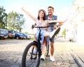 Happy funny young couple riding on bicycle Royalty Free Stock Photo