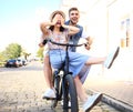 Happy funny young couple riding on bicycle Royalty Free Stock Photo