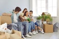 Happy funny young family with kids having fun in their new house full of cardboard boxes Royalty Free Stock Photo