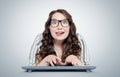 Happy funny young girl programmer in glasses with keyboard in front of computer Royalty Free Stock Photo