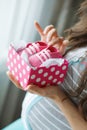 Happy future mother with pink booties in hand Royalty Free Stock Photo