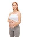 Happy future mother touching her belly