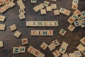 Happy game night. Leisure activities concept. Colourful square wooden letters on a dark wooden table creating the words Royalty Free Stock Photo