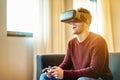 Happy gamer man playing video games virtual reality glasses in his apartment - Young person having fun with new trends technology Royalty Free Stock Photo