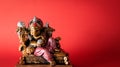 Happy Ganesh Chaturthi festival, Bronze Ganesha statue and Golden texture with flowers, Ganesh is hindu god of Success