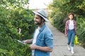 happy gardener trimming bushes near blurred