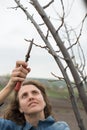 Happy gardener woman using pruning scissors in orchard garden. Pretty female worker portrait