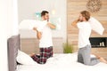 Happy gay couple having pillow fight on bed Royalty Free Stock Photo