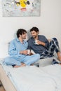 happy gay couple holding cups of Royalty Free Stock Photo