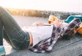 Happy gay couple lying next to the beach at sunset - Lesbian women having a tender romantic moment outdoor Royalty Free Stock Photo