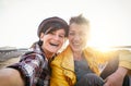 Happy gay couple taking selfie on the beach at sunset - Young lesbians having fun dating first time Royalty Free Stock Photo