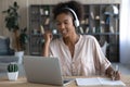 Happy gen Z African student girl in headphones watching webinar Royalty Free Stock Photo