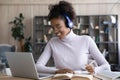 Happy gen Z Black student girl in headphones learning online