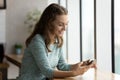 Happy gen Z girl with smartphone receiving good news Royalty Free Stock Photo