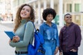 Happy german female student with backpack and group of international students Royalty Free Stock Photo