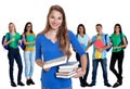 Happy german female student with books and group of students Royalty Free Stock Photo