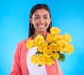 Happy, gift and a portrait of a woman with flowers isolated on a blue background in a studio. Smile, holding and a girl Royalty Free Stock Photo