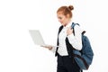 Happy gigner student woman with backpack holding laptop computer Royalty Free Stock Photo