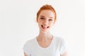 Happy ginger woman in t-shirt showing her tongue