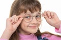 Happy girl adjusts his glasses and looks into the frame, close-up