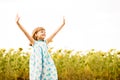 Happy girl admire nature with hands up in sunflowers field Royalty Free Stock Photo