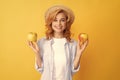 happy girl with apple fruit. vitamin and dieting. woman in straw hat eating healthy food. Royalty Free Stock Photo