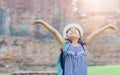 Happy girl with backpack play flower Royalty Free Stock Photo