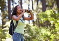 Happy girl, binoculars and nature with backpack for sightseeing, explore or outdoor vision. Young female person, child Royalty Free Stock Photo