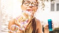 Happy girl blowing soap bubbles outdoor - Young woman having fun outside Royalty Free Stock Photo