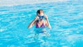 happy girl in blue goggles swimming in the swimming pool Royalty Free Stock Photo