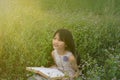 Happy girl with a book in the park