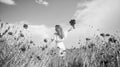 happy girl with bouquet of red flowers. summer vacation and holiday. pretty woman in white dress walking in poppy field Royalty Free Stock Photo