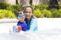 Happy Girl and Boy Enjoying in Swimming Pool Royalty Free Stock Photo