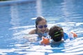 Happy Girl and Boy Enjoying in Swimming Pool Royalty Free Stock Photo