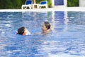 Happy Girl and Boy Enjoying in Swimming Pool Royalty Free Stock Photo